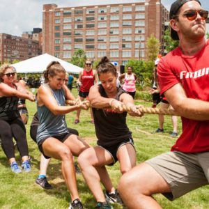 Atlanta, GA, USA - July 16, 2016:  A team of young adults pulls their rope in a tug-of-war contest as part of Atlanta Field Day in the Old Fourth Ward Park on July 16, 2016 in Atlanta, GA.